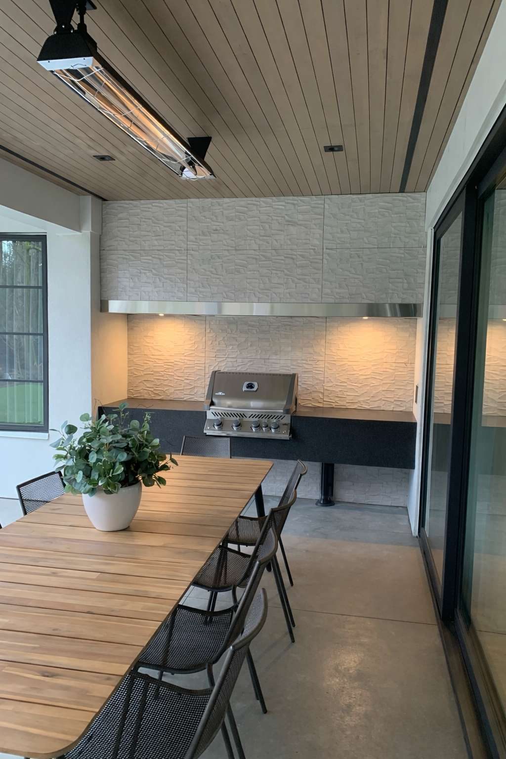 Covered outdoor kitchen finished by Yurtec Interiors